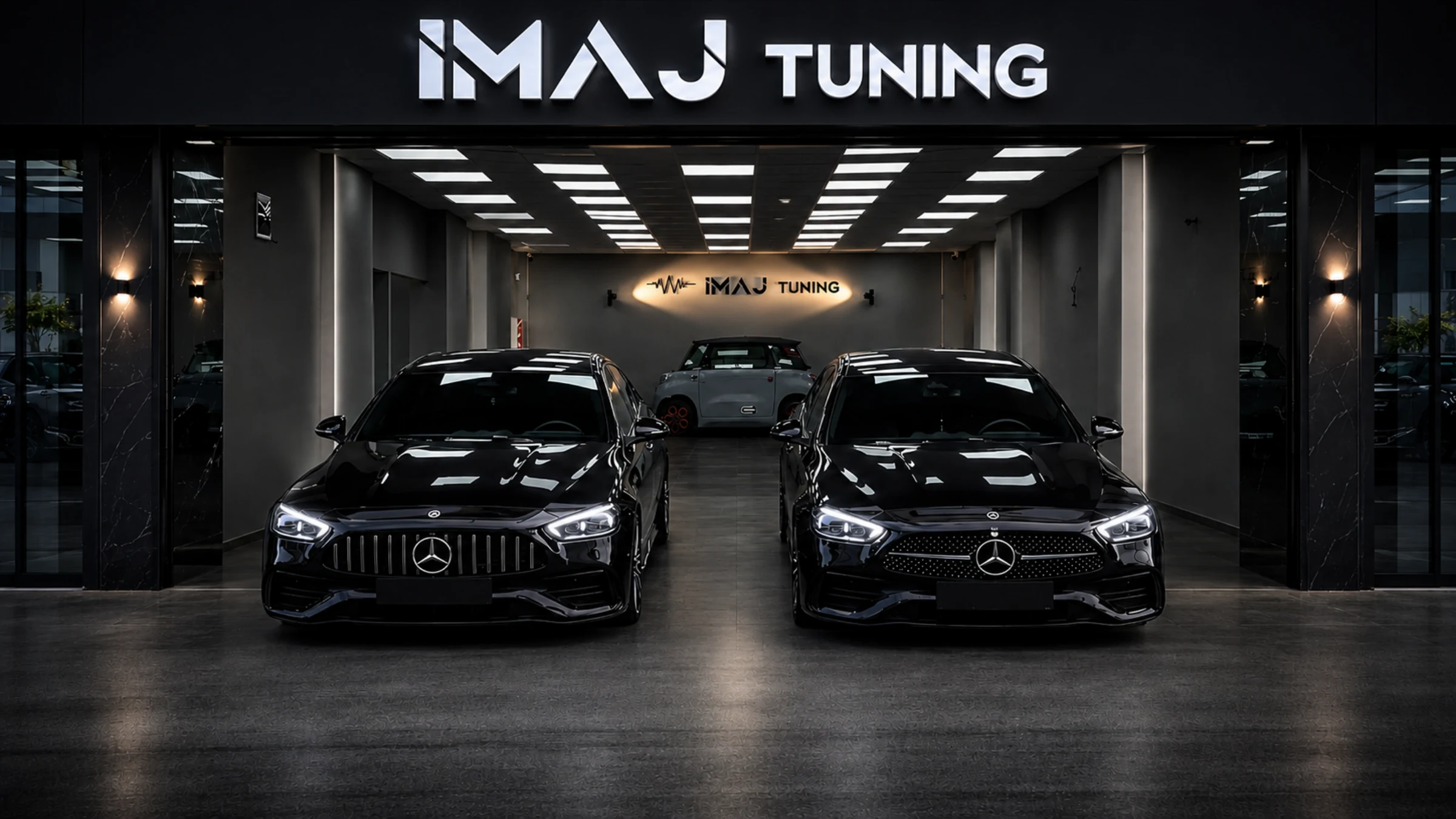 PPF İzmir İmaj Tuning stüdyosu — kırmızı neon tabelalı mağaza cephesinde iki siyah Mercedes